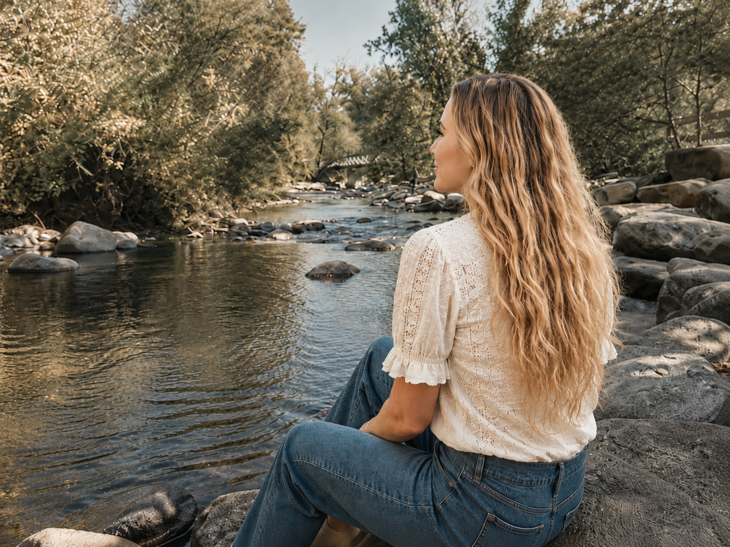 Maggie sitting by a peaceful Boulder creek